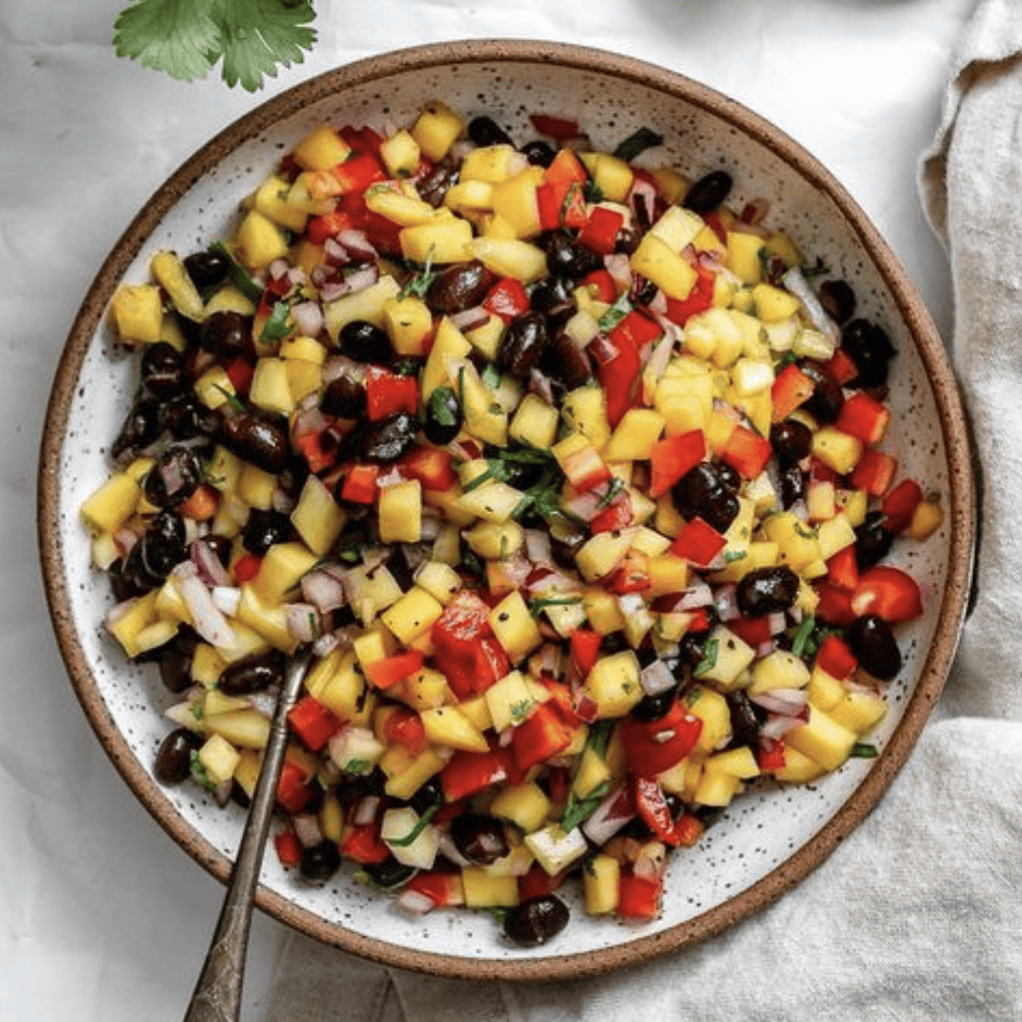 completed mango salsa plated against a white background